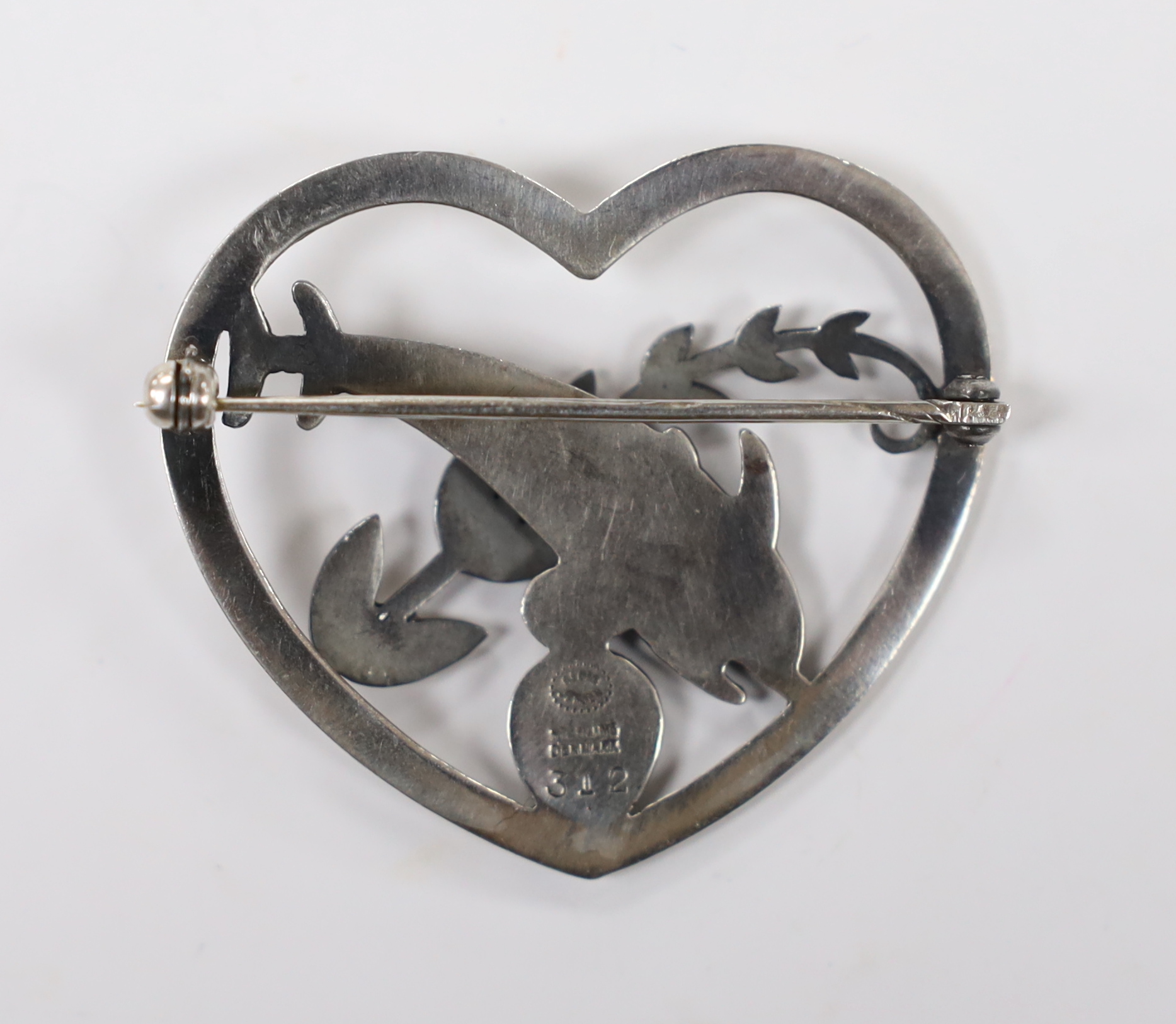 A George Jensen sterling 'twin dolphin, shell and frond' heart shaped brooch, design no. 312, width 41mm.